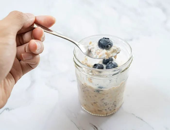 Someone eating overnight oats.
