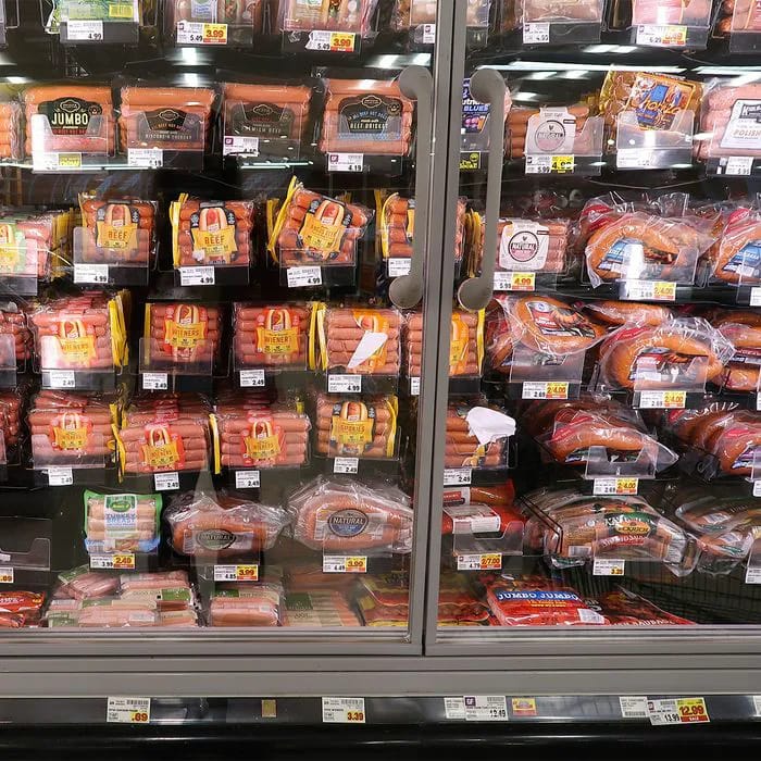 "Hot dogs and sausages displayed in a store"