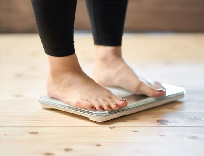 Person standing on a scale.
