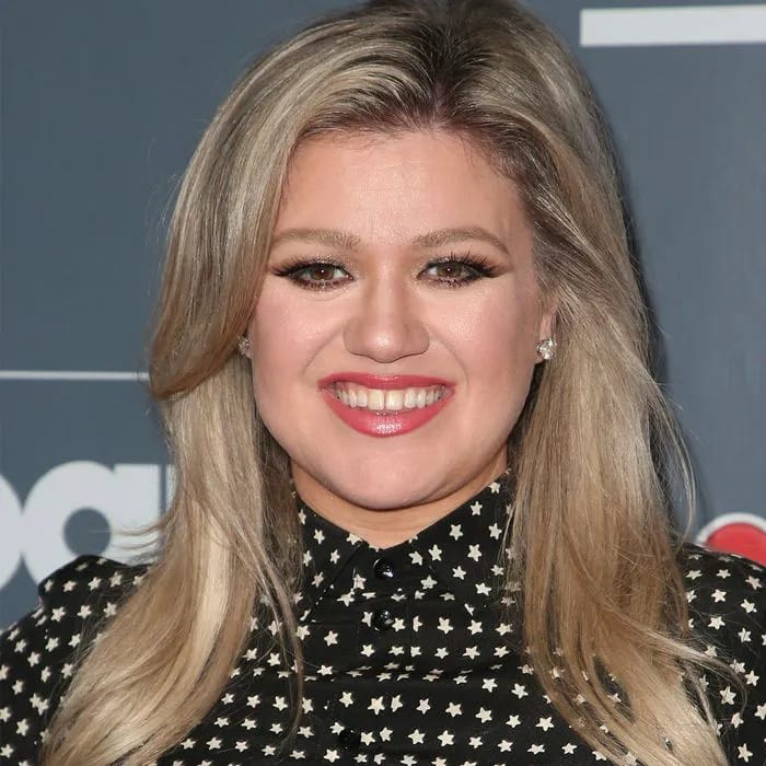 "Kelly Clarkson during a heartfelt moment on her show"