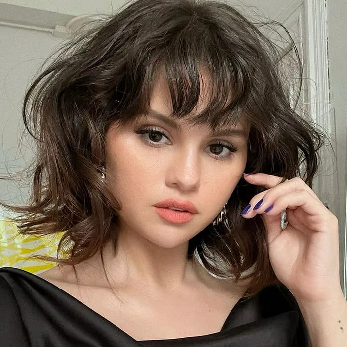 "Selena Gomez wearing sheer tights and a tweed mini dress"
