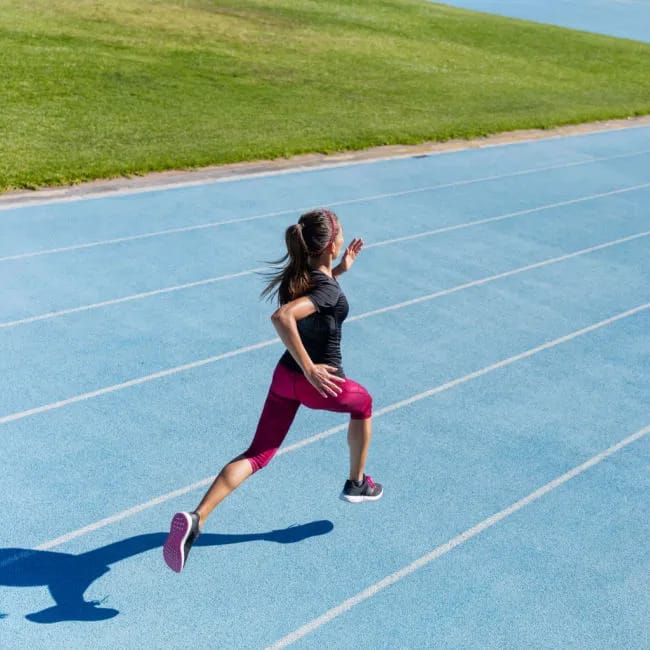 woman sprinting on track