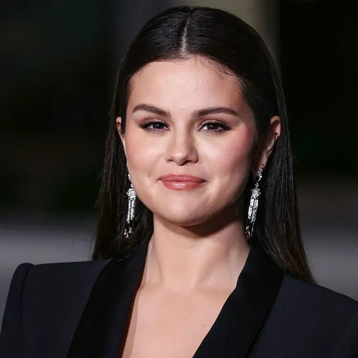 Selena Gomez smiling brightly at a public event.