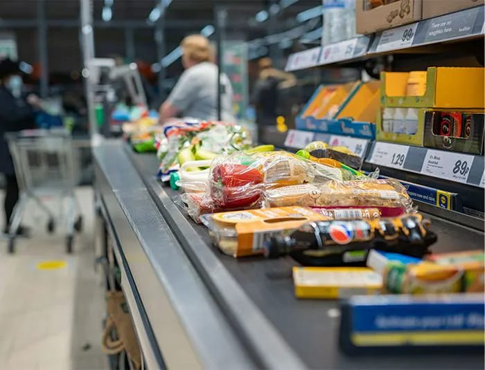 "Grocery store checkout line with various products"