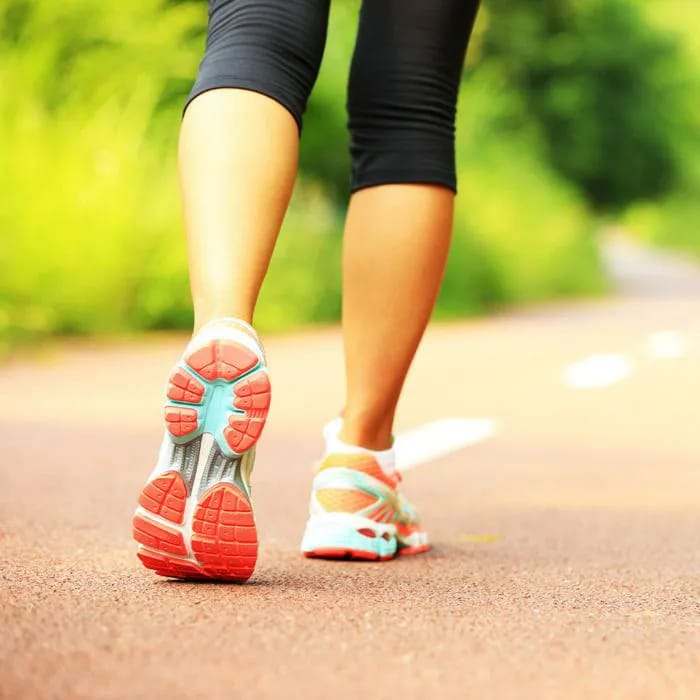 a woman goes for jog in sneakers