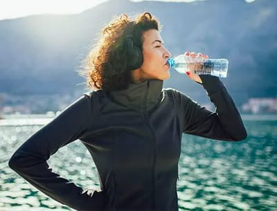 Woman drinking water.