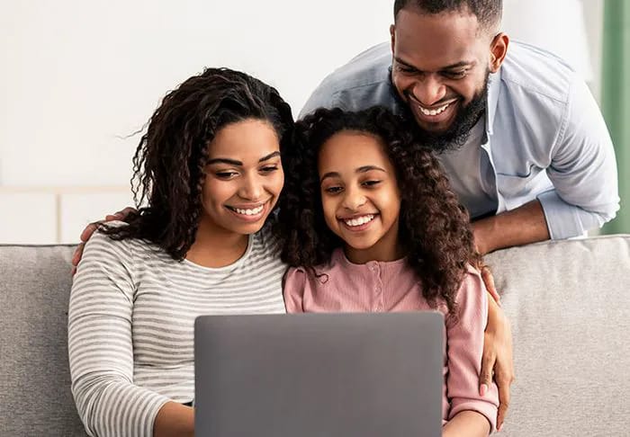 New Technology Family in front of a laptop