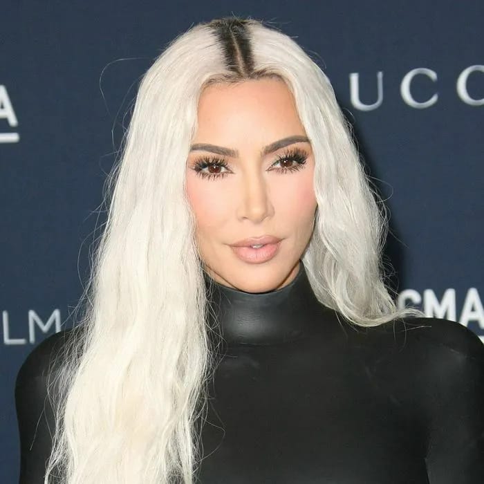 "Kim Kardashian in a black crocodile leather halter outfit"