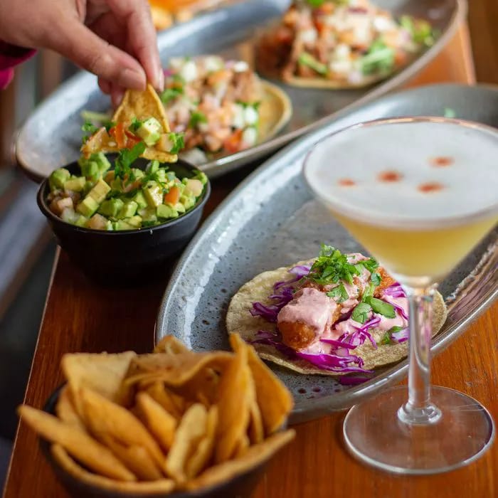 Colorful Mexican dinner with tacos and guacamole for better sleep.