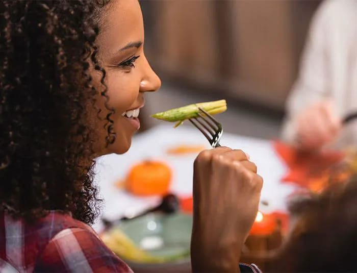 Woman eating asparagus