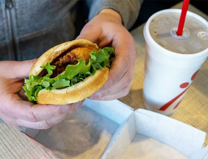 Man holding a Chick-fil-A sandwich