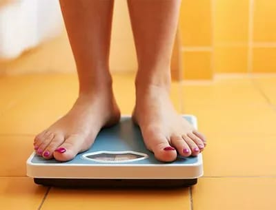Woman standing on a scale