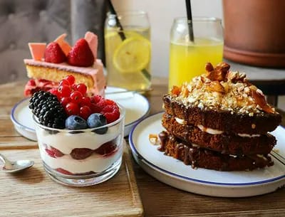table full of various desserts at cafe