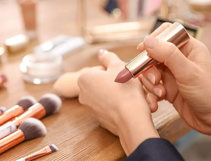 woman-applying-lipstick-hand