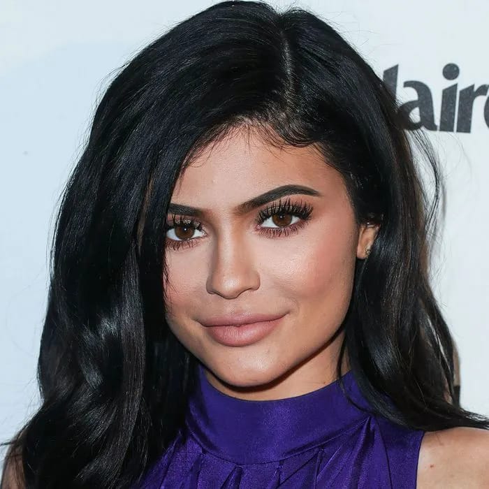 Kylie Jenner showcasing a stunning purple dress at an event.