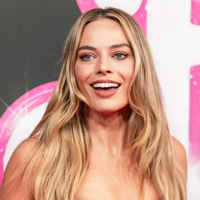 Margot Robbie shines in a figure-flattering dress at Barbie celebration.