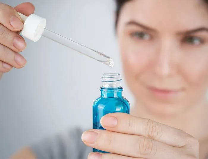 women-looks-at-skincare-serum