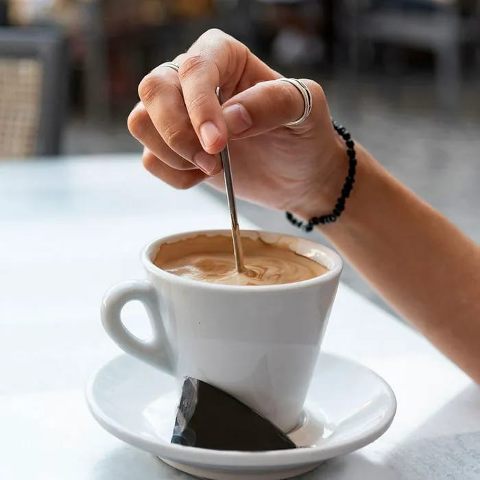 Woman stirring coffee in a mug