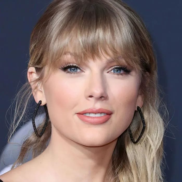 "Taylor Swift at the 2019 American Music Awards in a mini skirt and see-through top"