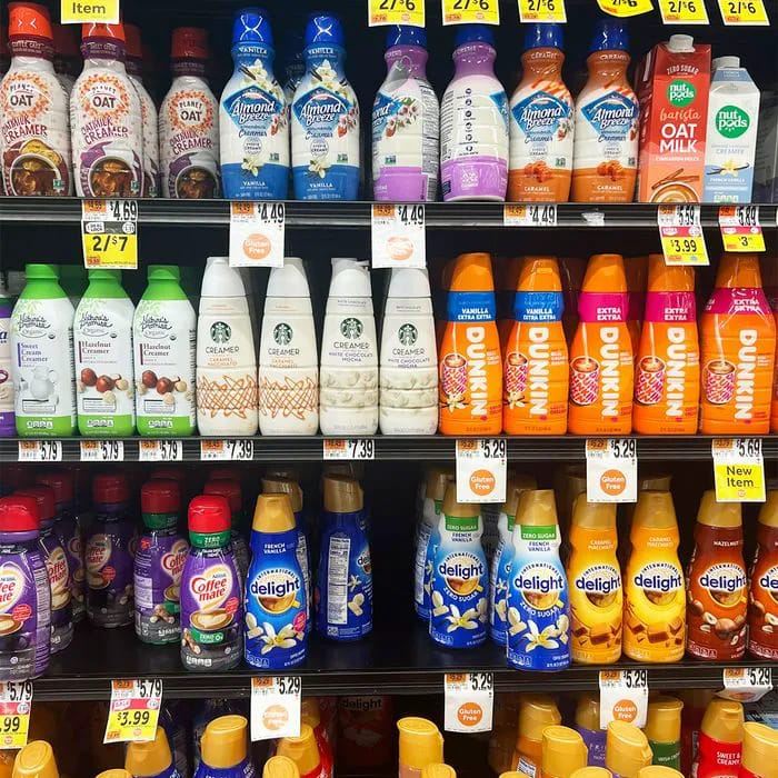 Bottled creamers lined up at a grocery store