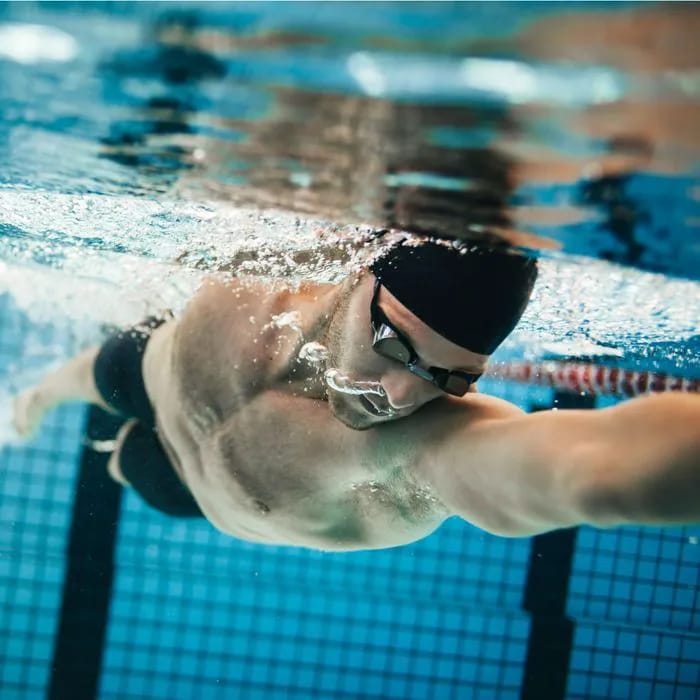 man swimming in pool