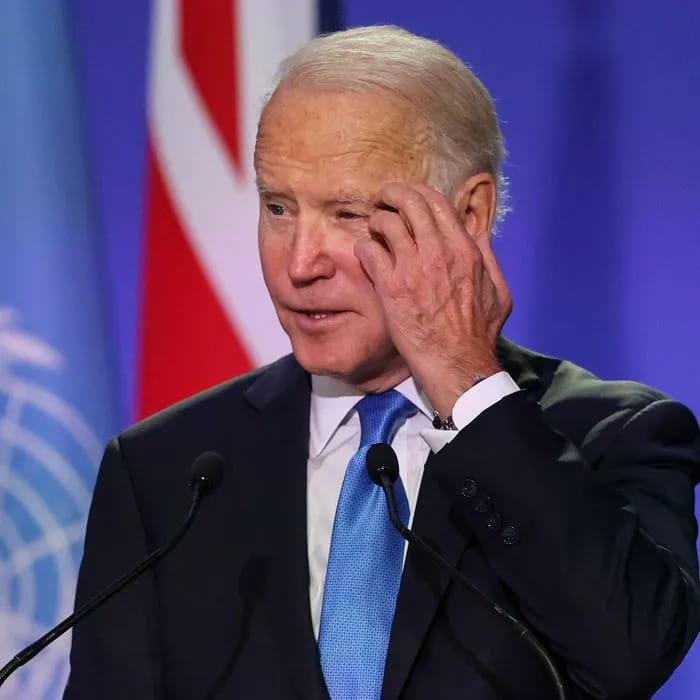 Joe Biden scratching his head in contemplation.
