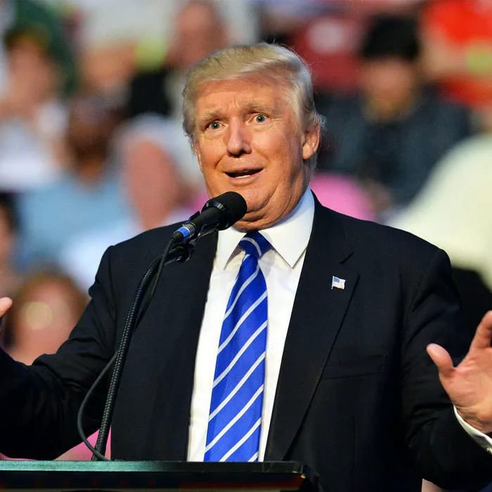 Donald Trump greeting supporters at his campaign event.