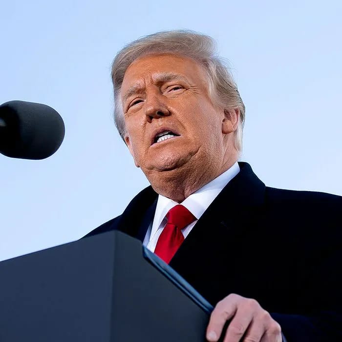 Donald Trump addressing the audience at a podium.