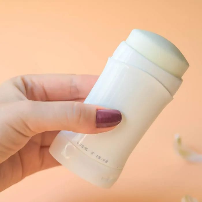 person holding stick of deodorant