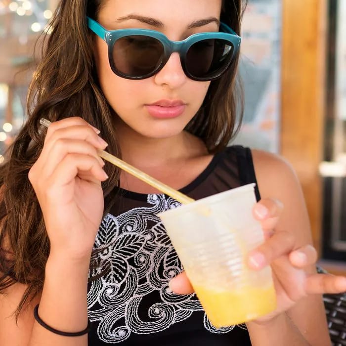 Woman sipping a refreshing beverage while on vacation.
