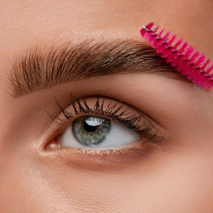 "Makeup artist applying makeup to a client"