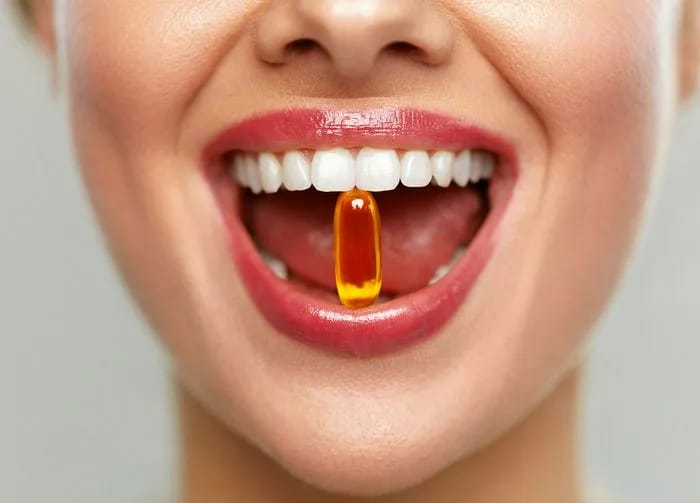woman-holding-supplement-mouth