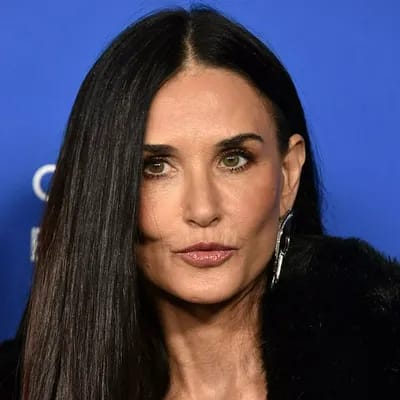 Demi Moore in stylish fur coat, showcasing natural beauty.