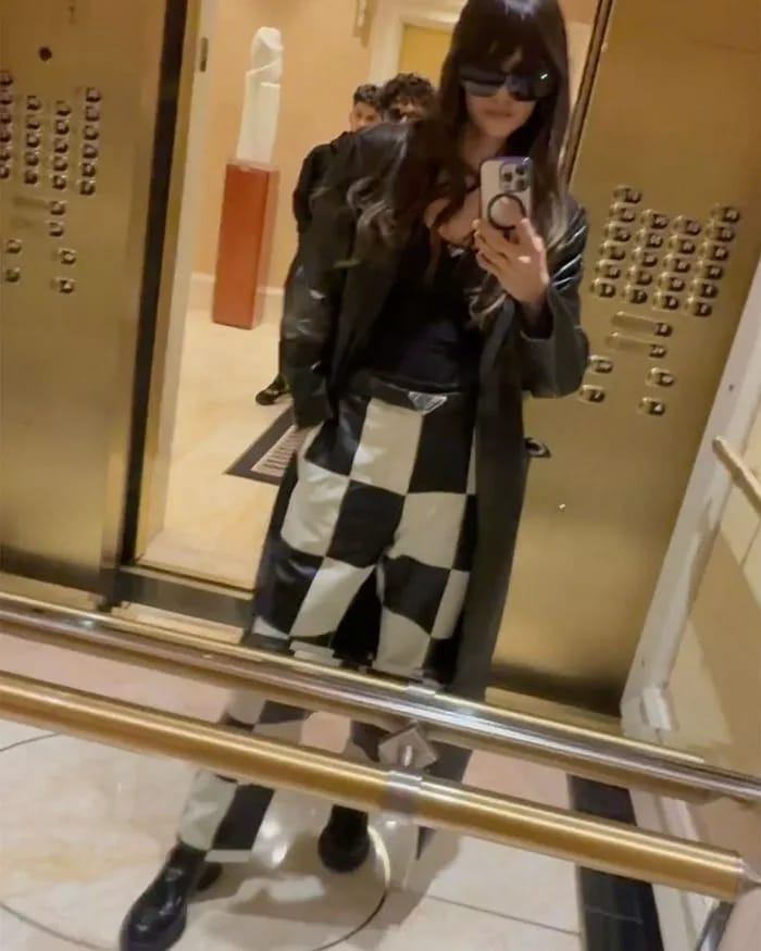 "Nina Dobrev in checkered pants at Formula 1"