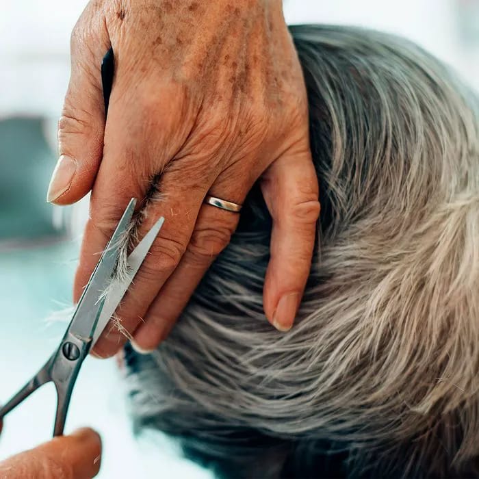 "Woman getting a medium haircut at a salon"