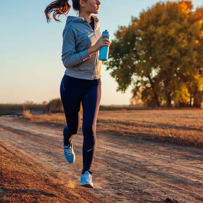 Woman jogging in winter for fitness and calorie burning