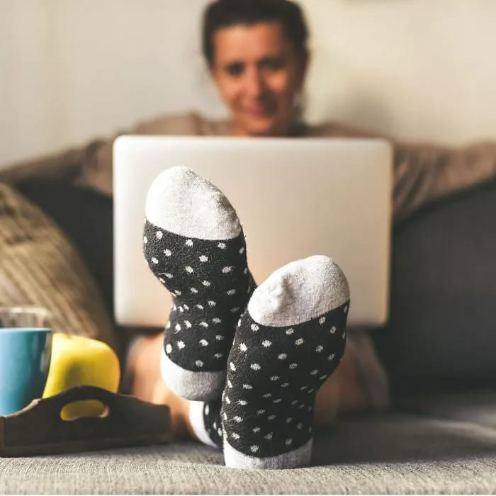 woman on couch on laptop