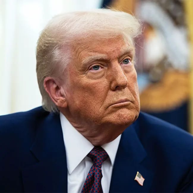 Donald Trump signing an executive order in the Oval Office