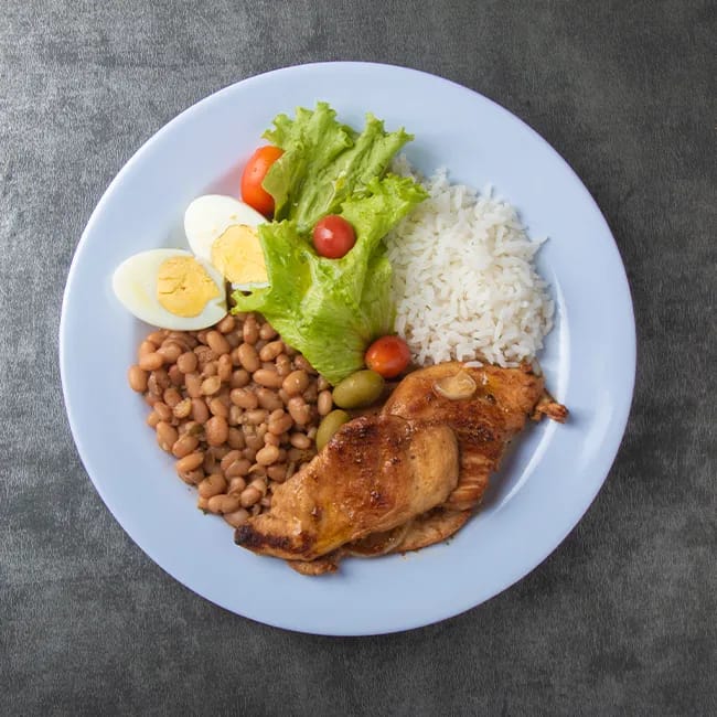 Brazilian food dish featuring rice, beans, and chicken