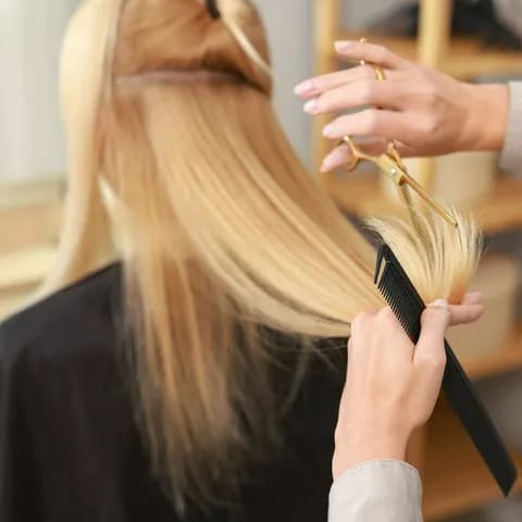 Long hair being cut in a professional salon.
