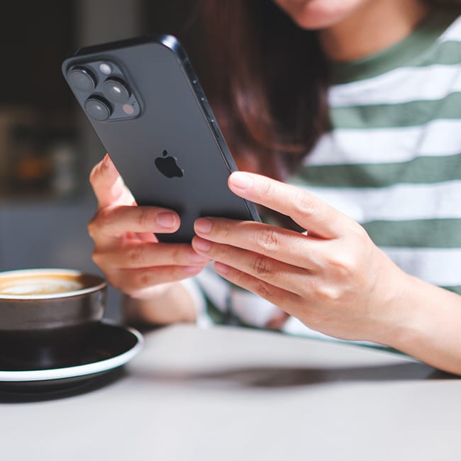 User interacting with an iPhone, exploring features.