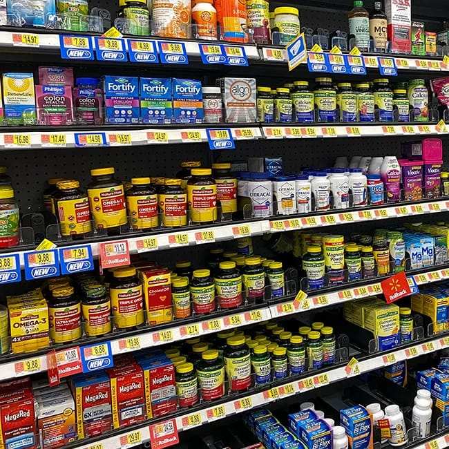 Vitamins and supplements neatly organized on a shelf.