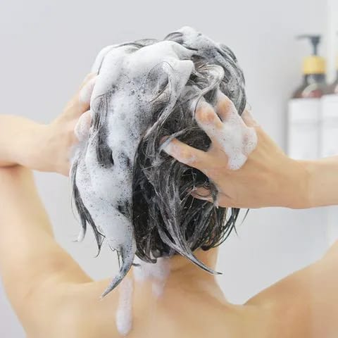 Washing hair in the shower for a fresh clean.