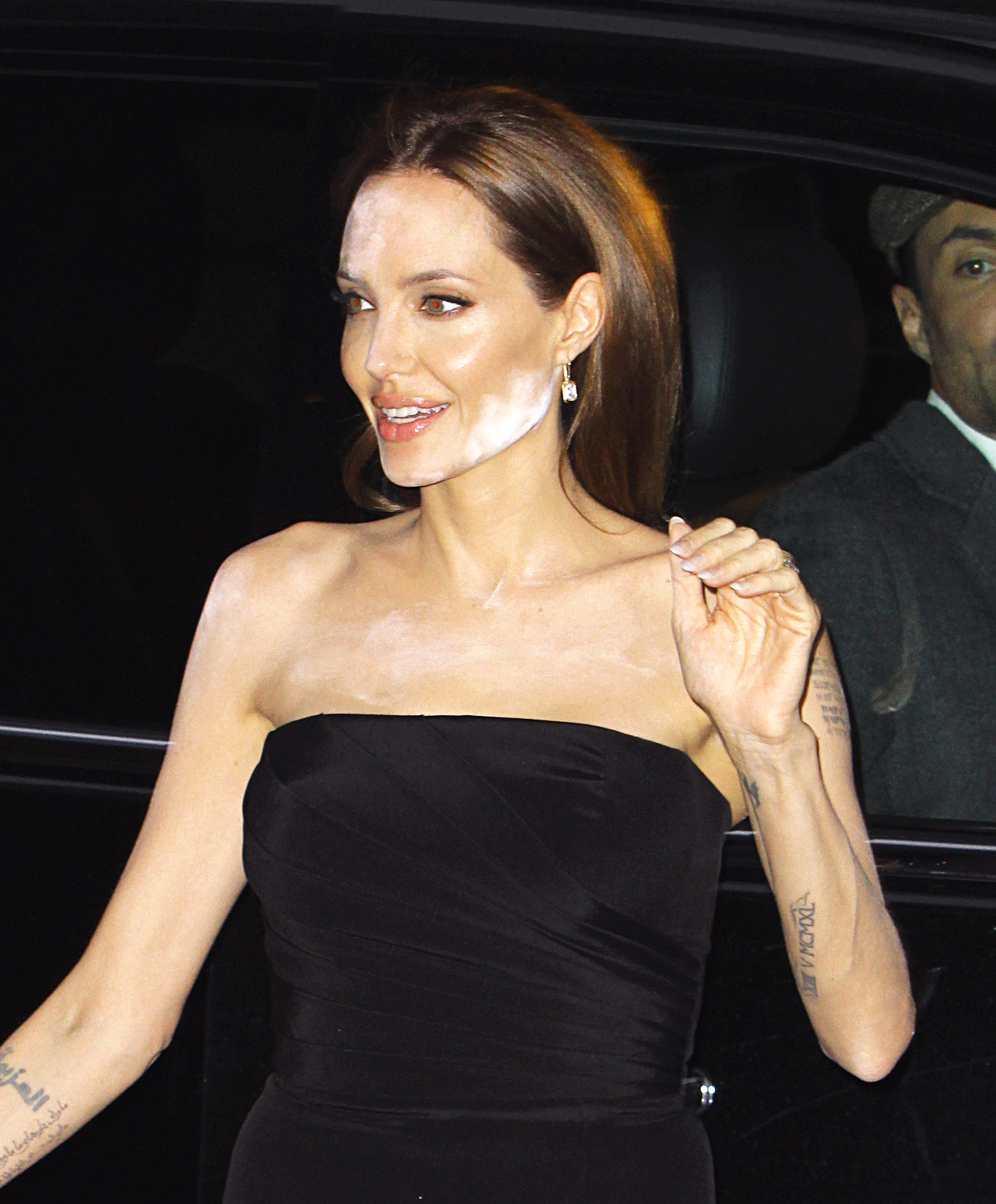 Angelina Jolie suffers a white powdered makeup malfunction while attending a screening for HBO's "The Normal Heart" with partner Brad Pitt in NYC.