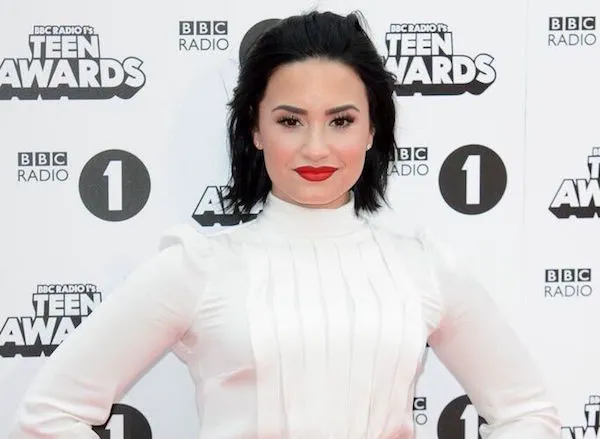 "Demi Lovato performing at a rally"