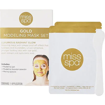 Gold modeling mask set for luxurious skincare treatment.