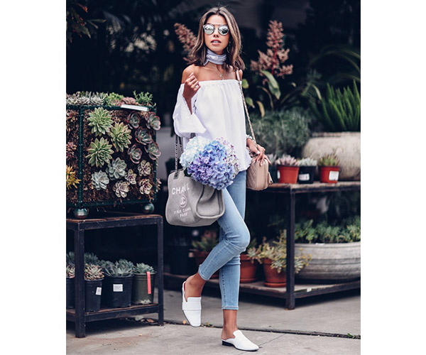 woman with white off the shoulder top and white mules