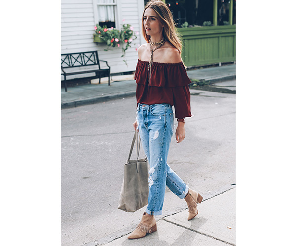 woman wearing a red off the shoulder top with tan stacked heeled booties