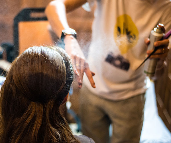woman getting hair sprayed