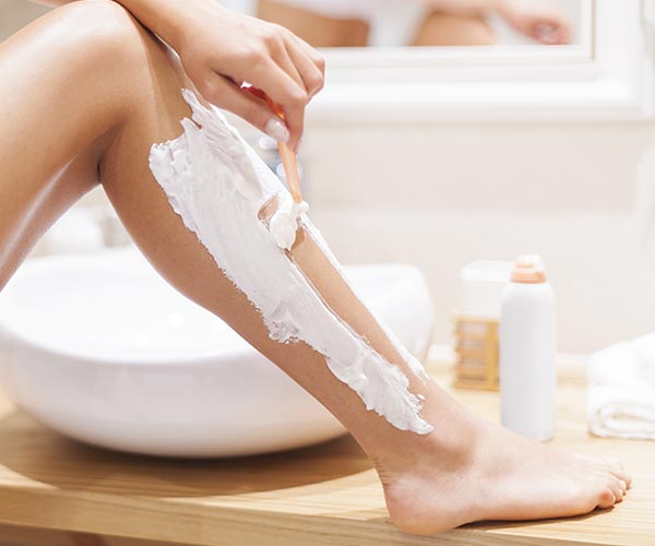 woman shaving legs